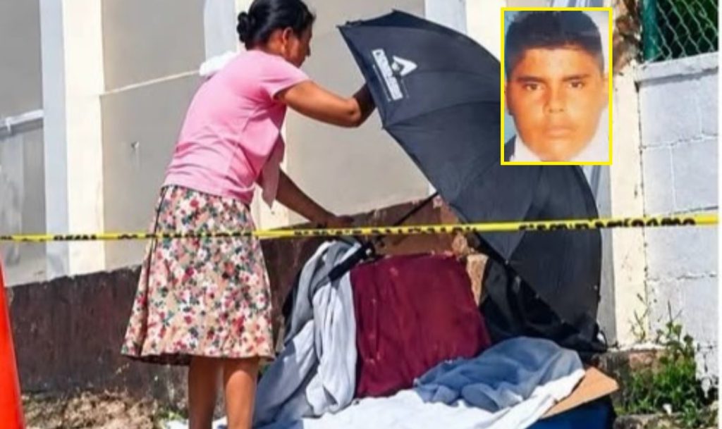 Hondureña cubre con sombrilla el cuerpo de su hijo a quien acababan de quitarle la vida
